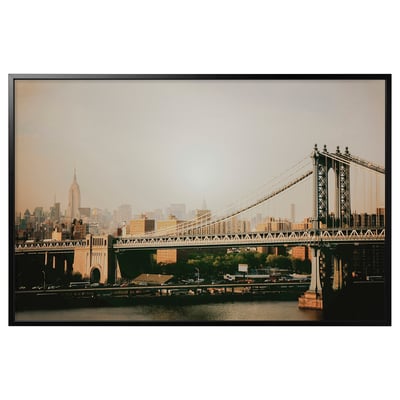 Framed photograph of manhattan bridge and nyc skyline in sepia tones.