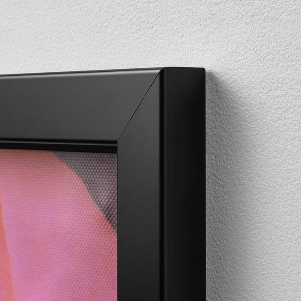 Close-up of a well-made, black picture frame on a wall, holding vibrant pink artwork. Clear, sharp edges indicate high quality.