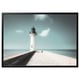 Bjorksta black-framed lighthouse canvas print. White lighthouse on clear blue ocean, calming coastal scene.