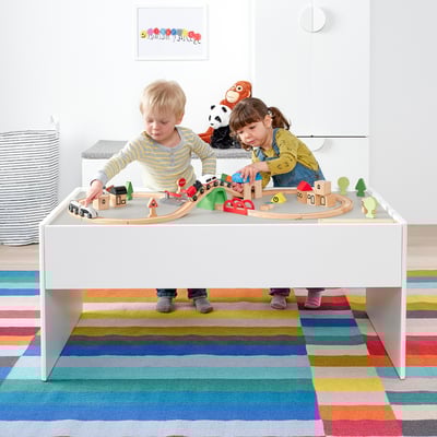 Kids playing with cars and blocks on a large DUNDRA table with a drawer, perfect for organising and creative play.