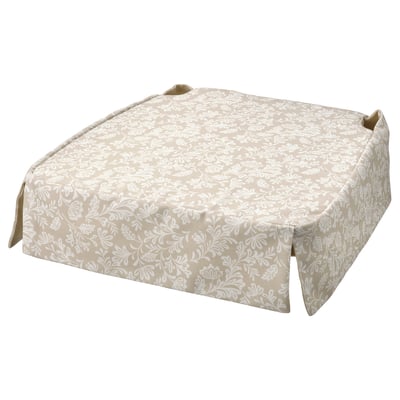 Beige floral chair pad with skirt-like design, round shape, and cushioned comfort.