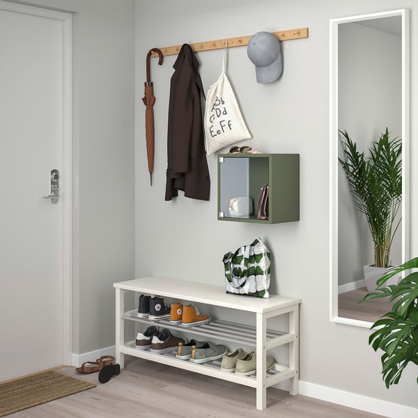 Entryway with shoe cabinet, coat rack, and plant.