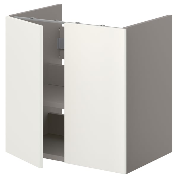 An IKEA ENHET white bathroom cabinet with one open door, revealing shelves.