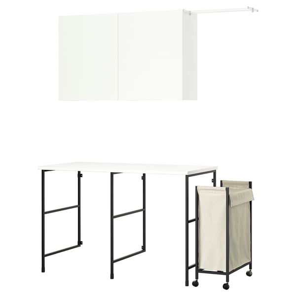 The ENHET laundry setup with white furniture and black metal frames, including a table, shelves, and a drying rail.