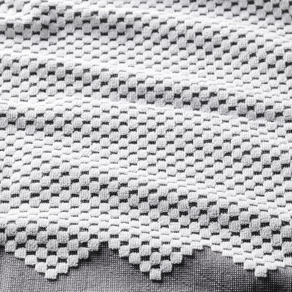 Close-up of jacquard-woven bohemian towel, soft cotton with intricate pattern.