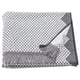 Grey & white fringed towel with intricate patterns, folded & displayed.