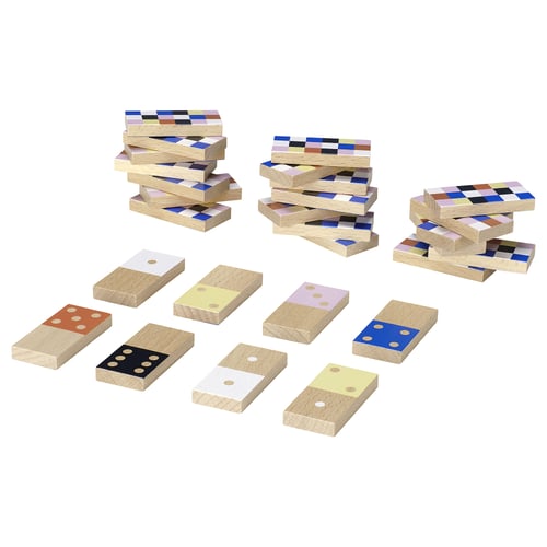 Colourful stacked wooden blocks of various sizes and colours, including blue, yellow, black, white, and orange dots, arranged in multiple piles.