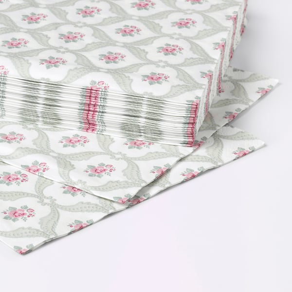 Stack of three-ply floral napkins, elegantly patterned, displayed on a white surface.
