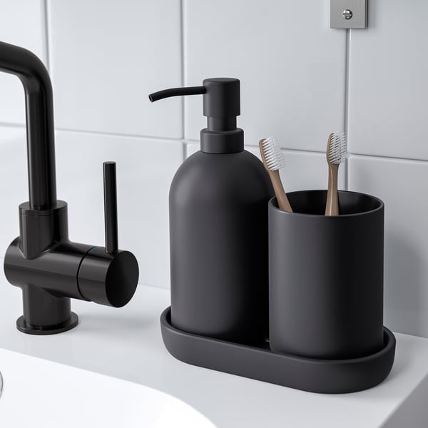Black bathroom accessories: soap dispenser, toothbrush holder, and tray on white sink.
