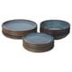 Three stacks of GLADELIG dinnerware, ocean-blue with golden-brown rims, in circular shapes, neatly displayed.