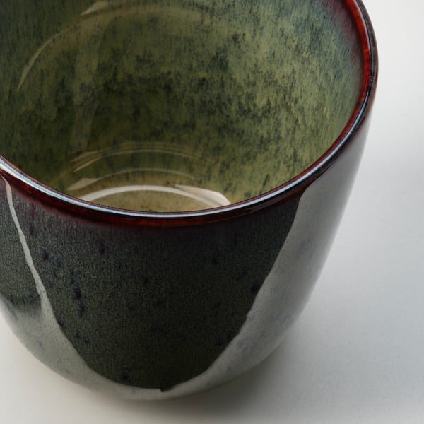 Handcrafted green cup, red rim