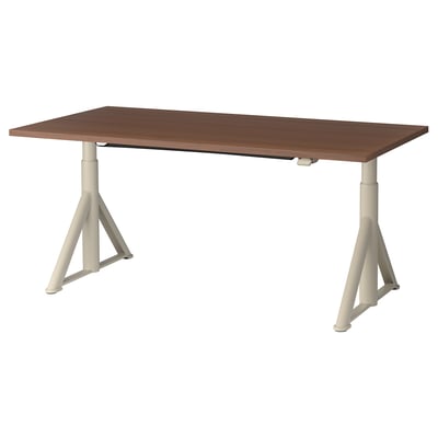 An idasen adjustable desk with a brown top and white legs, designed for both sitting and standing.