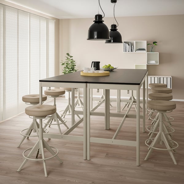 Modern kitchen with IDÅSEN bar table, light beige, seating six. High stools, pendant lamps, and minimalist decor.