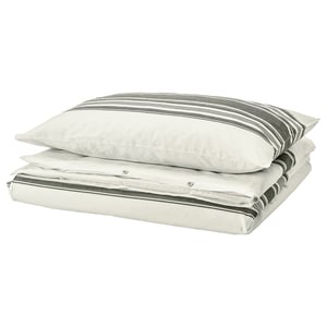 A JÄTTEFRÄKEN bedding set in white with dark stripes, made of cotton, featuring a folded duvet cover and pillows.