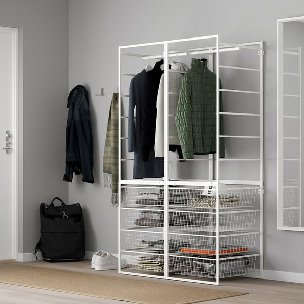 White JONAXEL storage with hangers and baskets, between door and window.