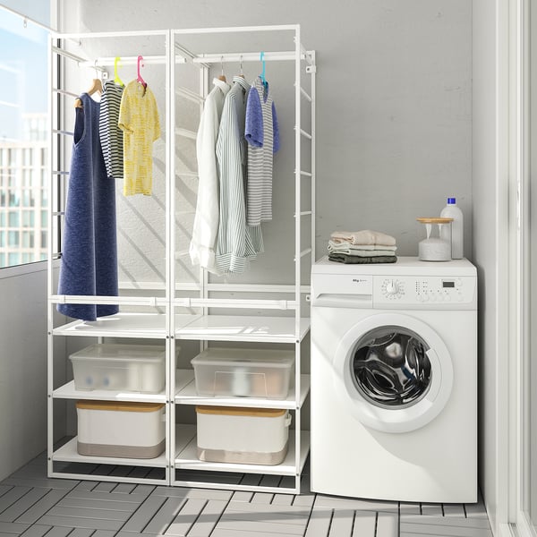 JONAXEL white laundry rack with clothes & baskets beside white washing machine, fitting neatly in space.