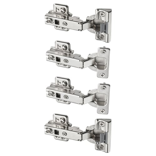 This image displays four KOMPLEMENT hinges in silver colour. They are metallic with plastic parts, designed for slow, silent door closure.