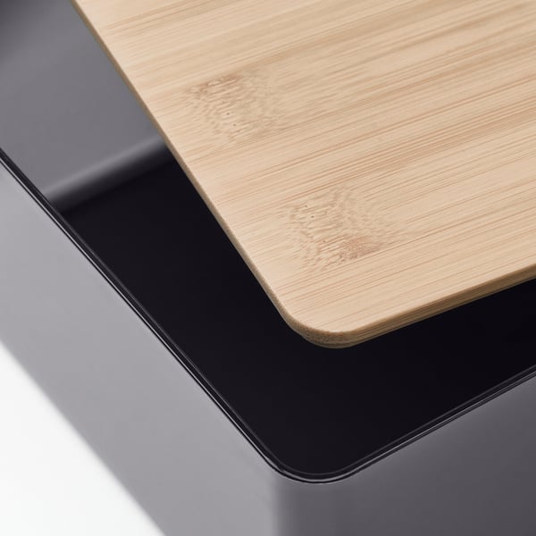 Close-up of a wooden box with a sleek, black border, showcasing its natural, smooth finish.