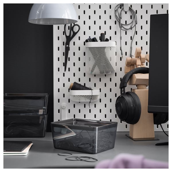Desk with KUGGIS boxes, scissors, headphones, lamp, monitor.