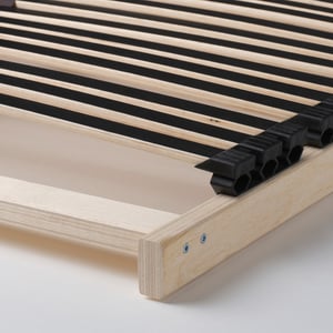 Close-up of a sturdy, wooden slatted bed base with adjustable support, showcasing quality construction and comfort.