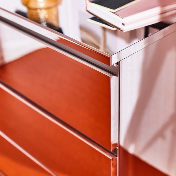 Modern, stylish dresser with reflective foil surfaces and sleek metallic edges, showcasing high-quality design and finish.