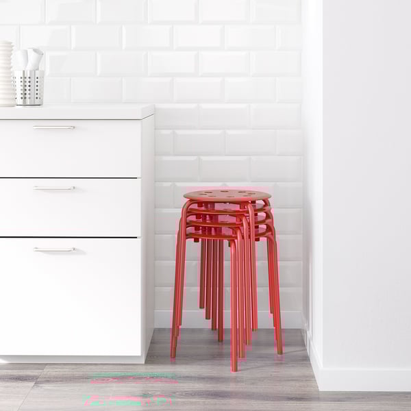 Stack of 3 red MARIUS stools against tiled wall.
