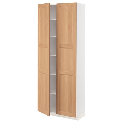 An open light wood cabinet from the METOD kitchen system, showcasing its adjustable shelves within.