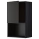 A black METOD wall cabinet with a modern, sleek design featuring a single dark grey door and open storage space below.