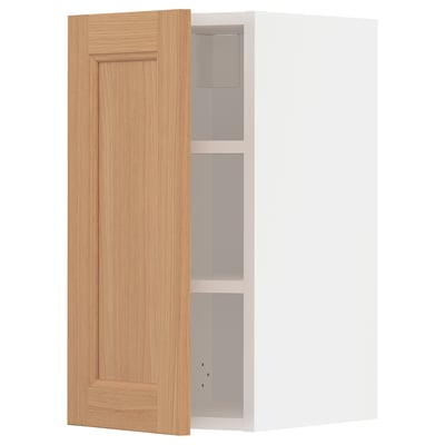 An open light brown wooden ikea METOD wall cabinet with a white interior and two shelves.
