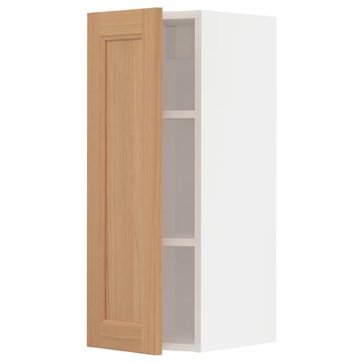 An open METOD kitchen cabinet with a wooden door in a light oak colour.