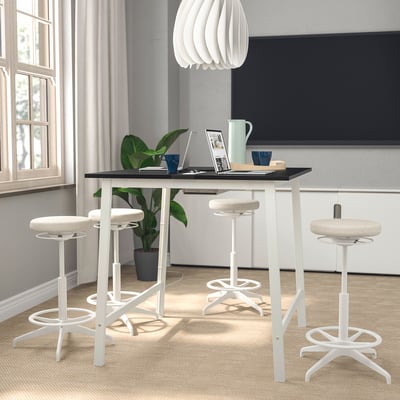 Modern MITTZON white office setup with four white stools, sleek black tabletop, and trendy light fixture, spacious and stylish.