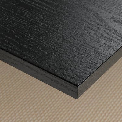 Close-up of black wooden table top with smooth, dark finish and clean edges.