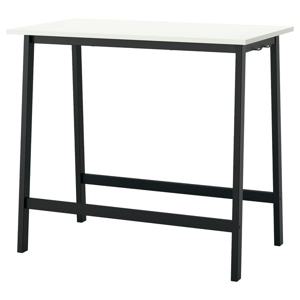 A MITTZON table. It is black with a white top, rectangular, and modern in design. Made of steel and plastic, it stands on four legs with a sleek look.