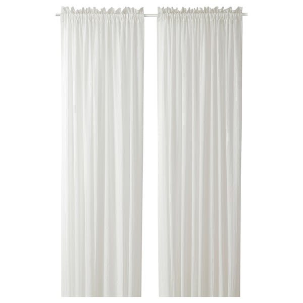 MUNKBOMAL sheer white curtains, made of 98% cotton, hang vertically, offering privacy and light.