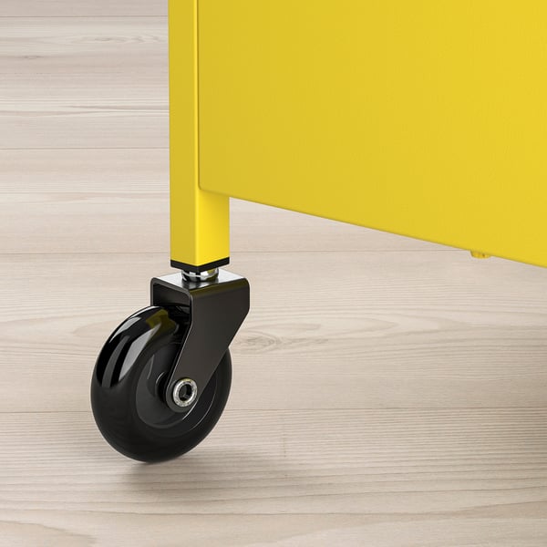 Close-up of a bright yellow NISSAFORS storage trolley wheel; sturdy, castor-equipped design.