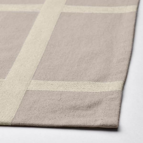 Neutral-toned cotton-jute tablecloth with subtle linear pattern, showcasing fine texture and quality fabric.