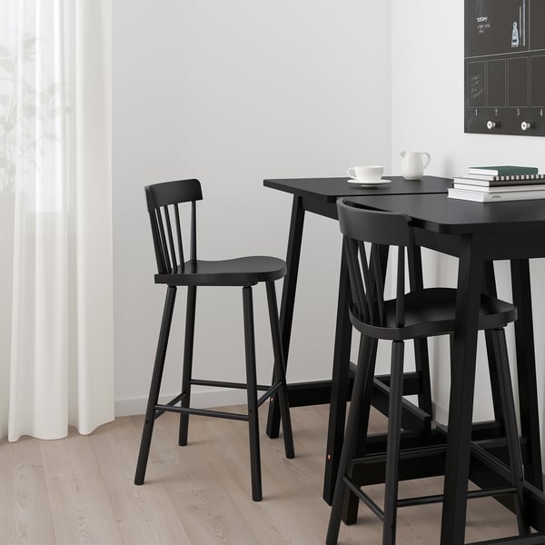 Black minimalist bar stools & table set, high, sleek, modern design, suitable for small spaces.