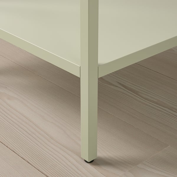 Modern cabinet with light mint frame and glass door on wood floor. High quality materials.