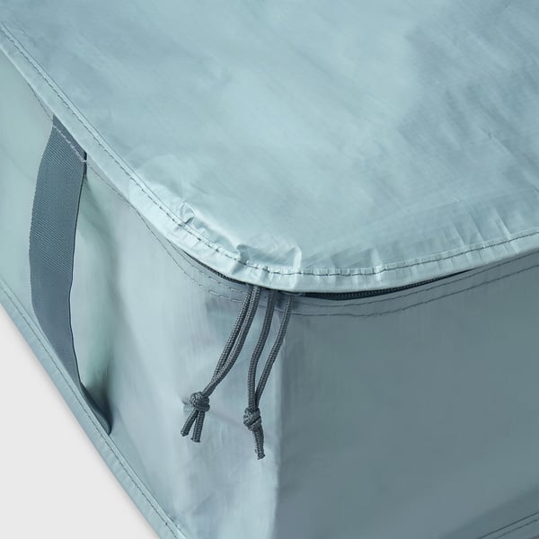 Close-up of a durable, light blue storage bag with strong stitching, a handle, and drawstrings.