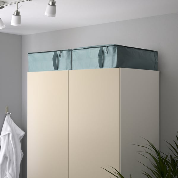 Two-tone wardrobe with zippered top section for storage.