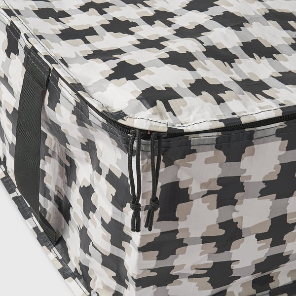 Close-up of durable, camo-patterned storage bag with sturdy zip and handles.
