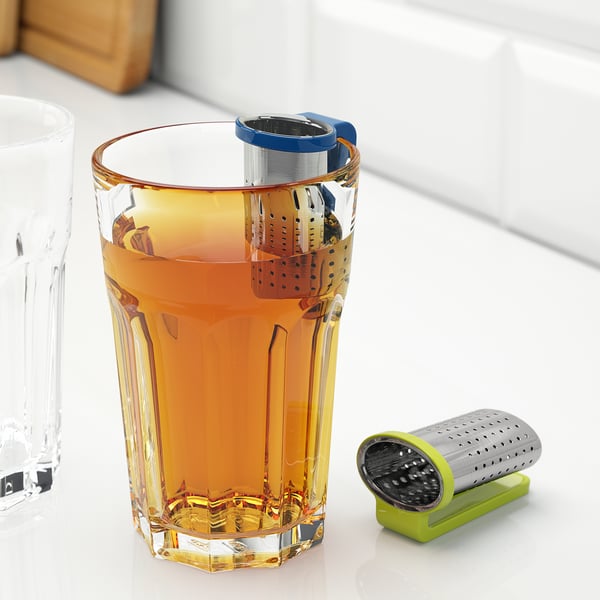 Glass mug with tea infuser. Infuser hangs on edge, preventing stains.