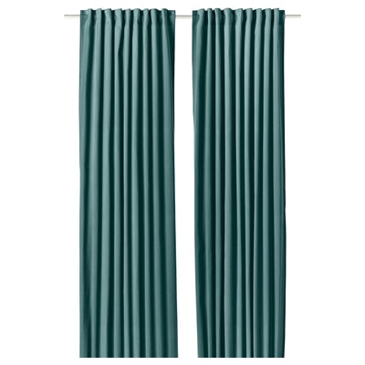Two dark grey-turquoise SANELA curtains hang side by side, featuring a luxurious velvet texture and a multi-way header design.