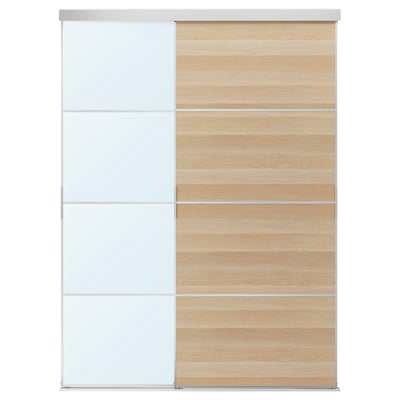 A SKYTTA dual-tone sliding closet door. One panel is white, the other light wood. The door has a sleek, modern design with four rectangular sections.