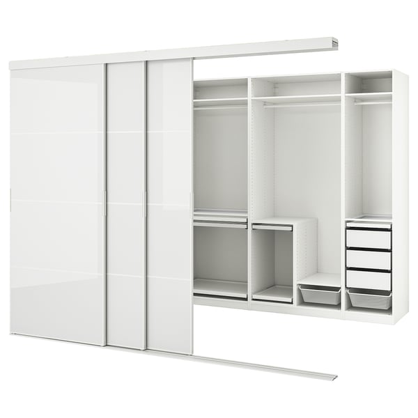 A white SKYTTA wardrobe with sliding doors and multiple compartments. It shelves, drawers, and a trouser hanger.