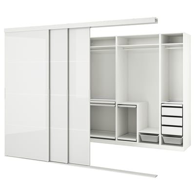 A white SKYTTA wardrobe with sliding doors and multiple compartments. It shelves, drawers, and a trouser hanger.
