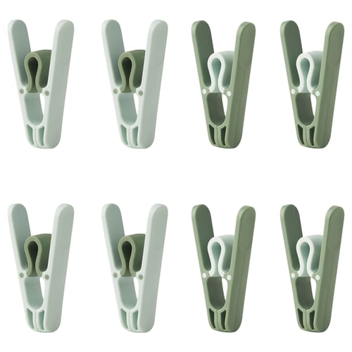 Eight green SLIBB clothespins arranged in two rows of four, featuring wide openings and robust design for hanging laundry.