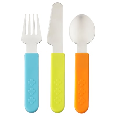 Three colourful childrens utensils: blue fork, yellow knife, orange spoon. Bright handles with floral designs, made of plastic.