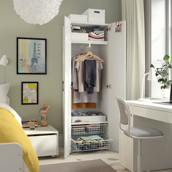 Open wardrobe displaying clothing and shelves, with a desk and chair visible, showcasing organisation and storage functionality.