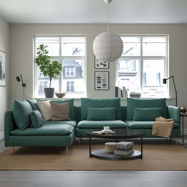 Modern living room with large green l-shaped SÖDERHAMN sofa, top coffee table, and large windows.